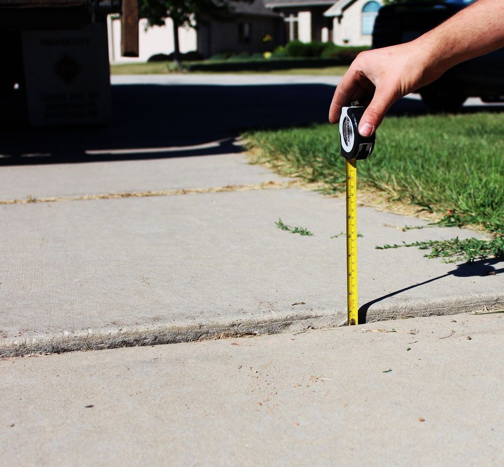 Uneven settled concrete panels that create a sidewalk trip hazard in Southeast Wisconsin